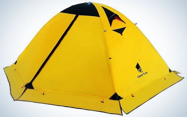 A camping tent all closed and solid yellow with some small black parts.