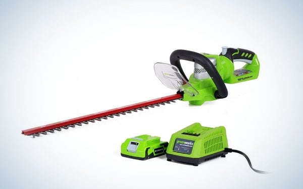Green, cordless hedge trimmer with battery and charger