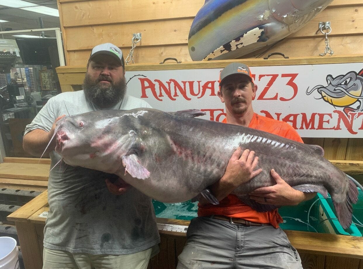 Rocky Baker, left, with the new record North Carolina blue cat. 