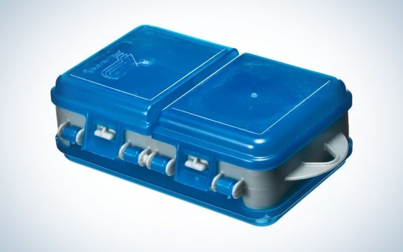 A closed box of strong blue color in the shape of a rectangle as well as in the shape of a suitcase.