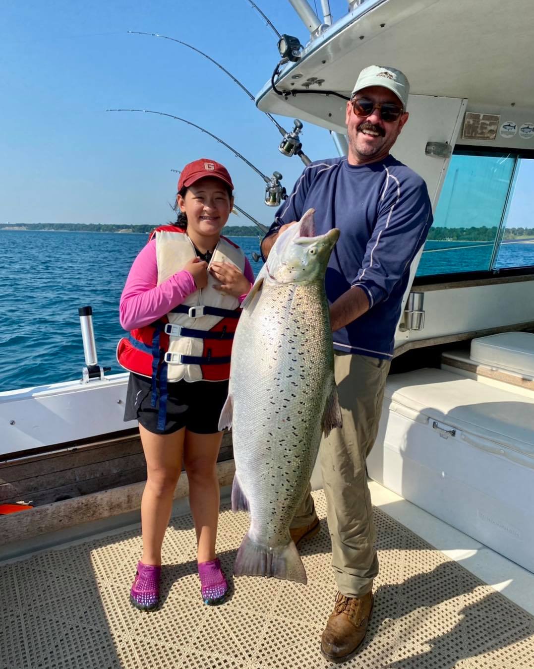Audrey Morgan (left) with her giant 31.5-pound Lake Michigan brown.