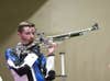 William Shaner of the United States reacts to a shot during the Tokyo 2020 men's 10m air rifle final in Tokyo.