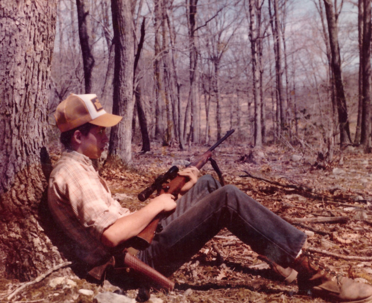 Hunter sitting against a tree for deer