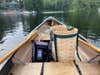 A canoe with a Garmin Striker 4 inside, sitting on a lake.