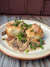 Braised meat with biscuits and gravy.