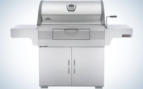 A large portable grill with four sturdy holders and all gray color with two spaces on the side.