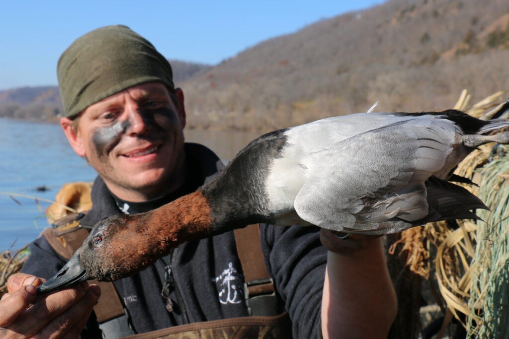 hunter with a canvasback duck