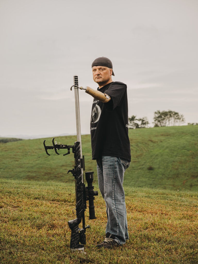 Aaron Miesse stands with his custom gun.