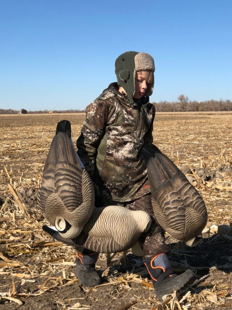 The author's son carrying full-body goose decoys