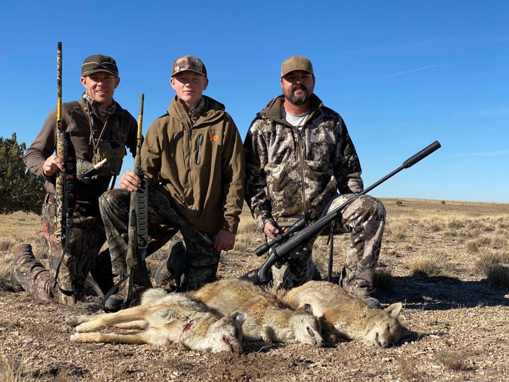 Hunters with three coyotes