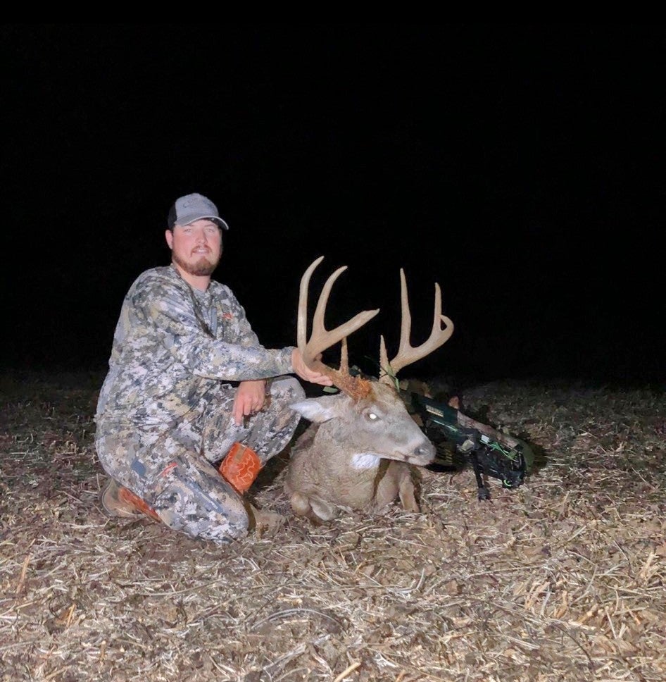 Hunter with an 8-point buck