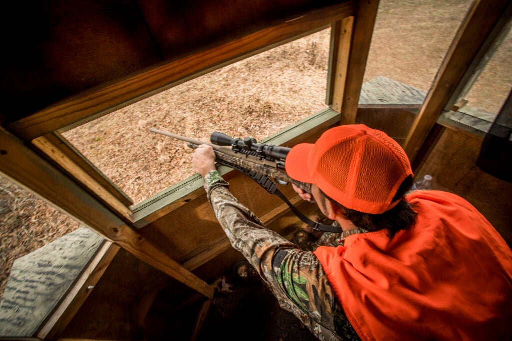 Hunter shooting from a deer blind