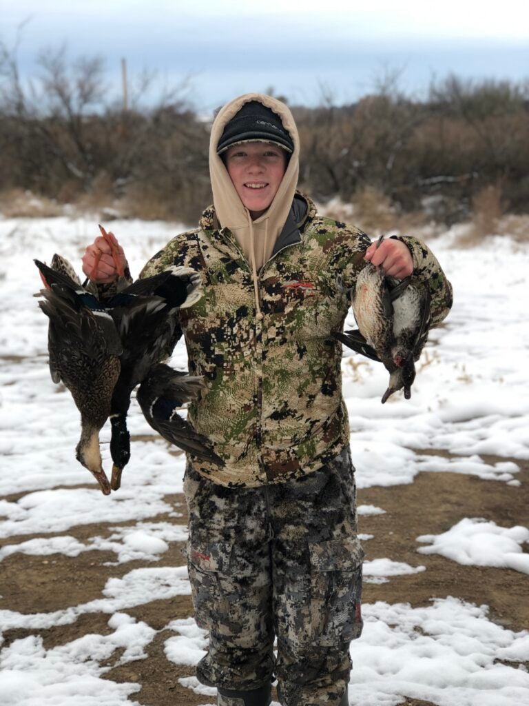 young hunter with ducks