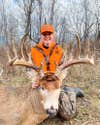woman poses with huge whitetail buck