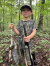 young hunter with squirrels