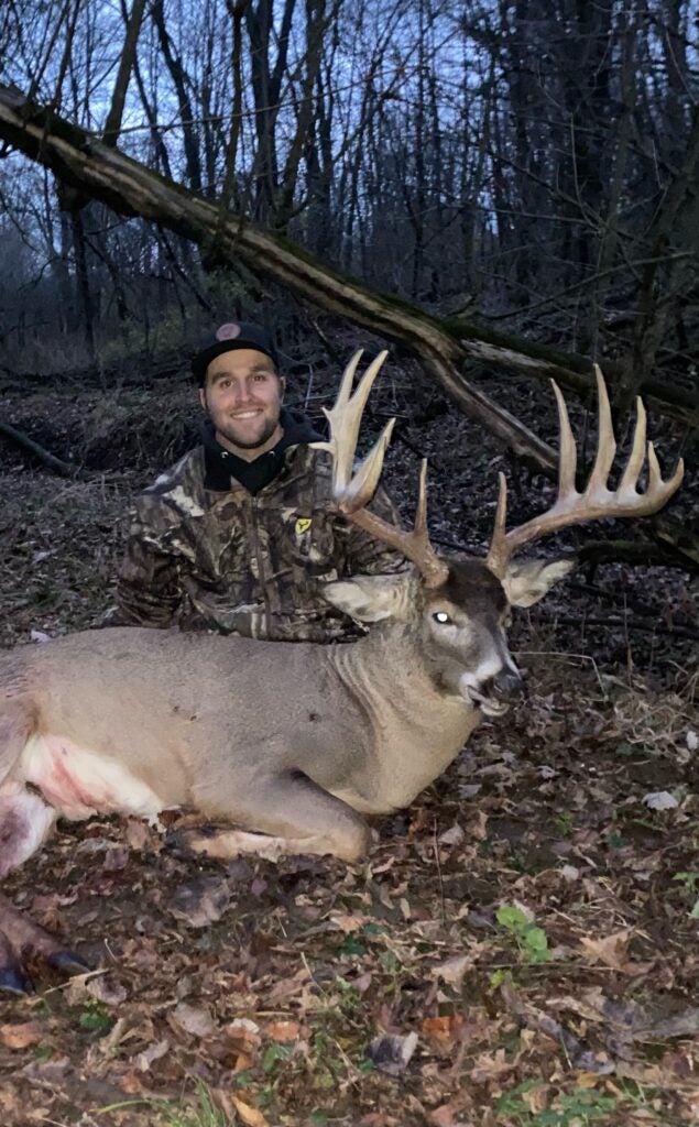hunter poses with big whitetail deer