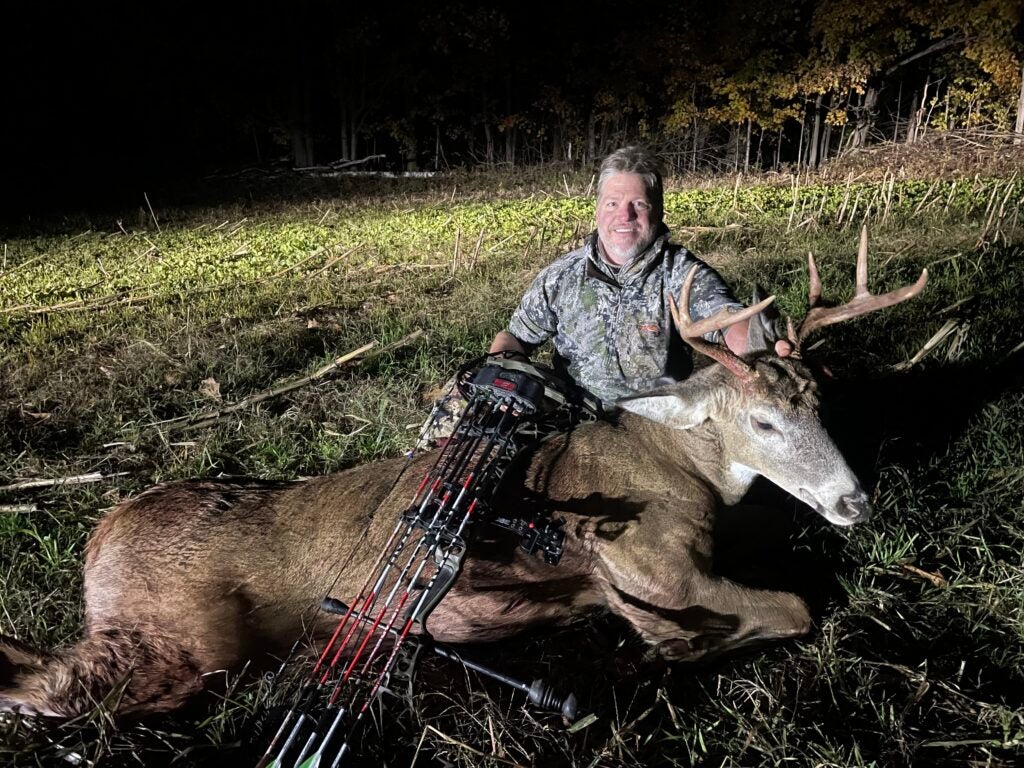deer hunter with a whitetail deer taken with a bow