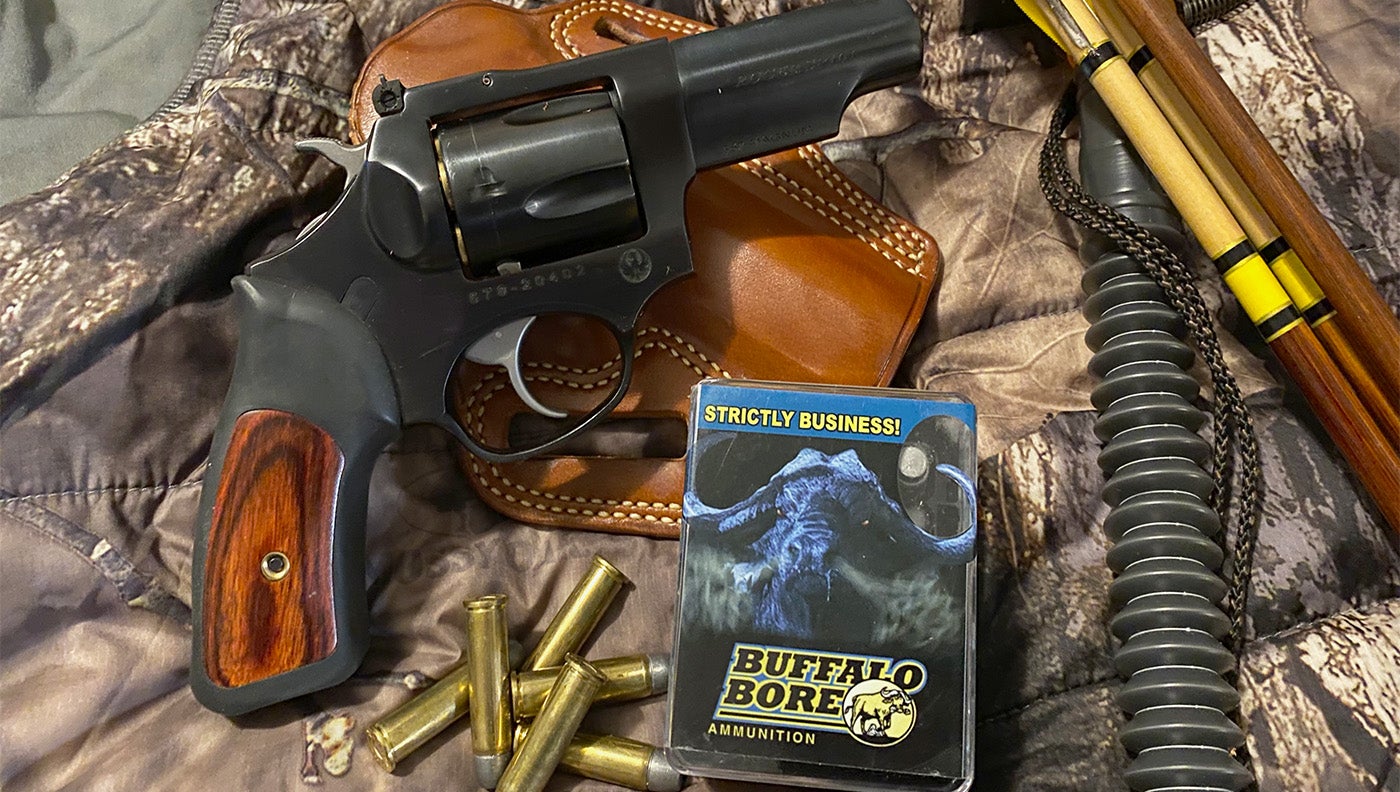 a photo of a handgun with hunting gear
