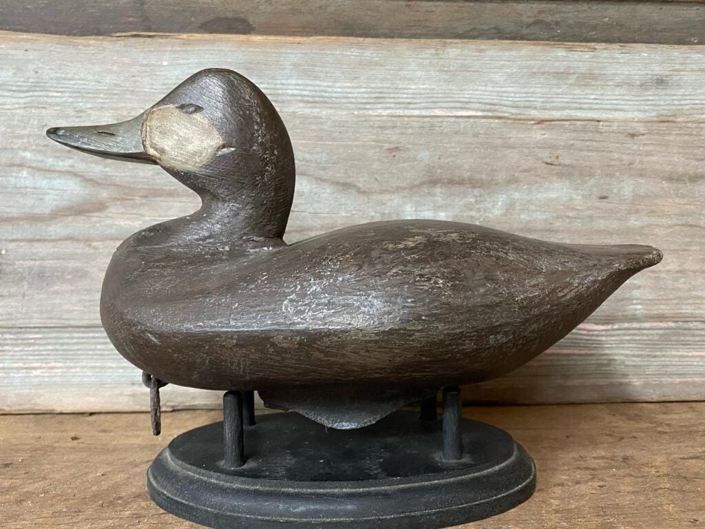 Jerry Talton decoy sitting on a stand.