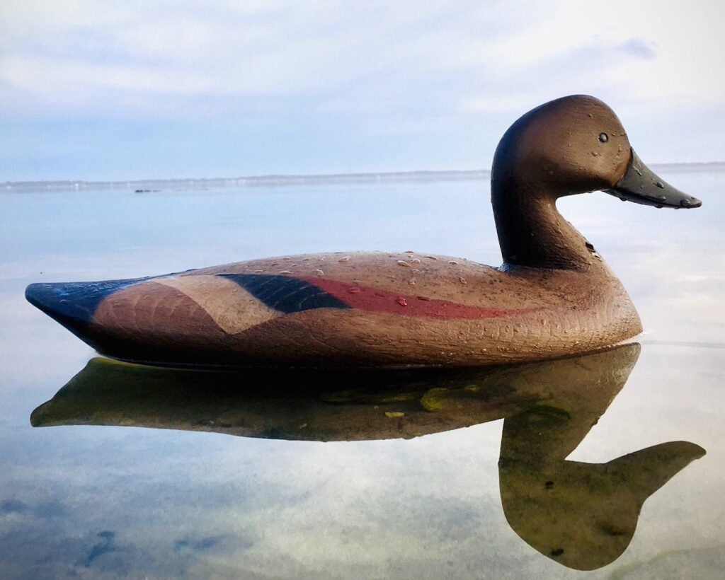 Hand-carved Jerry Talton decoy floating in the water