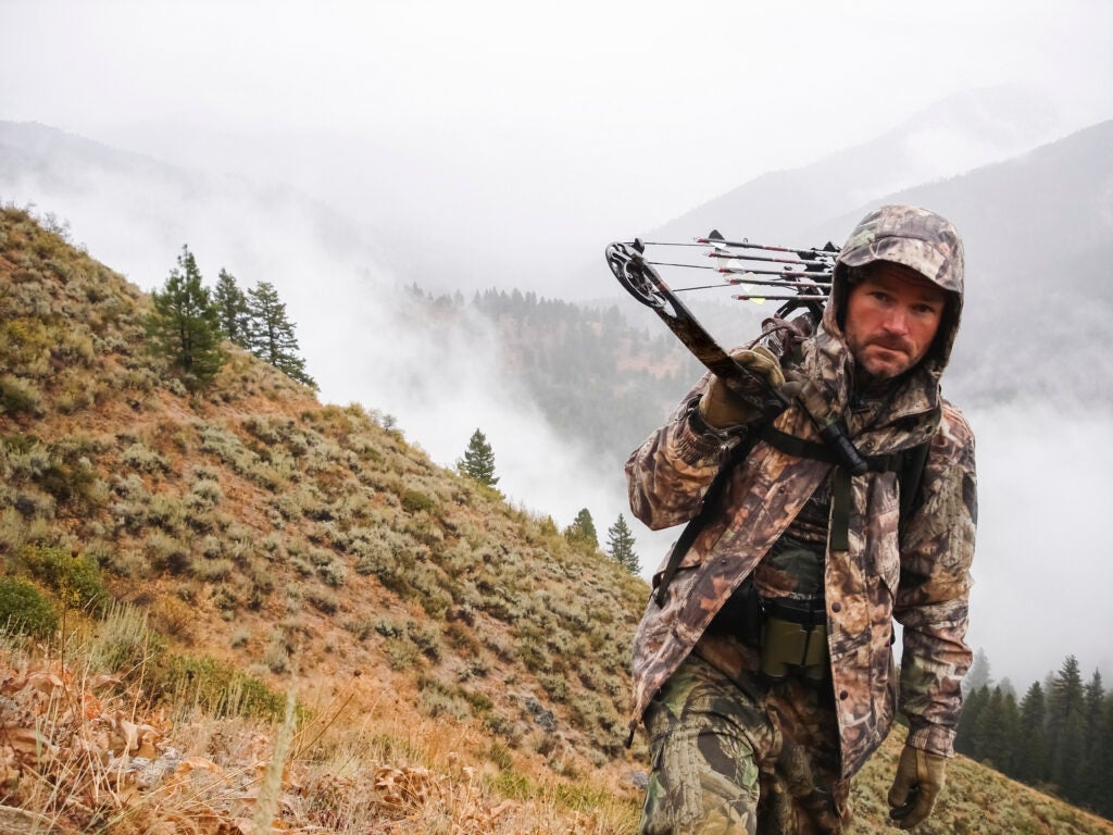 Bowhunter elk hunting in the mountains.
