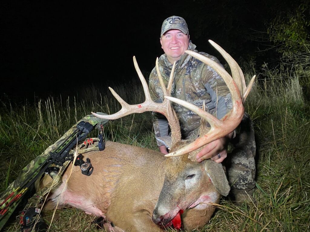 photo of hunter with huge whitetail buck