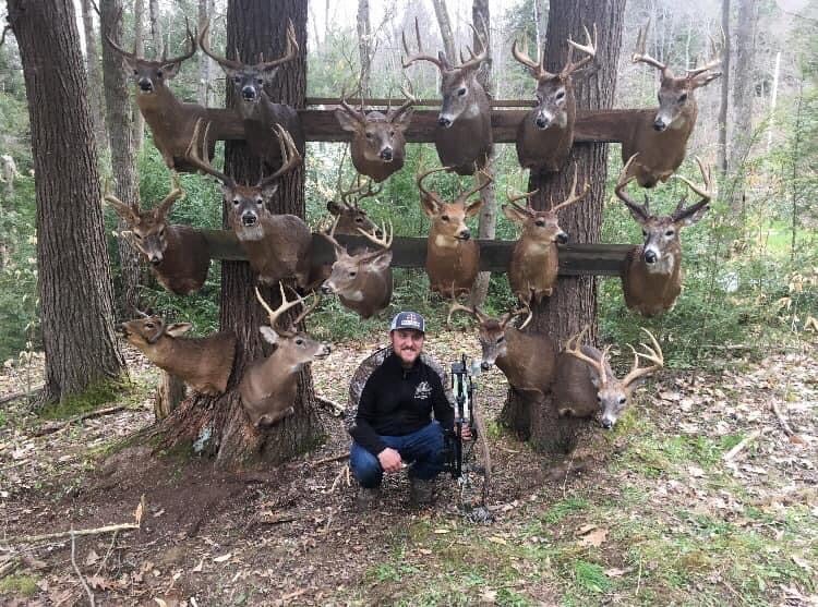 photo of hunter with whitetail deer mounts