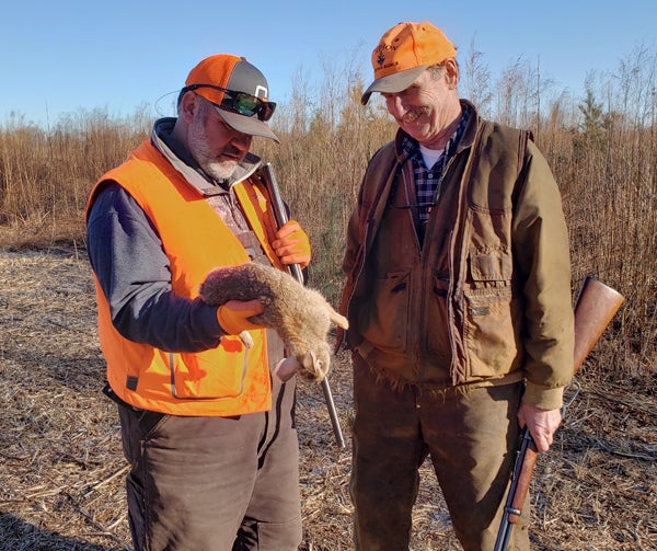 Chip Watkins (left) and Roger Summers with a late-season rabbit in Virginia.
