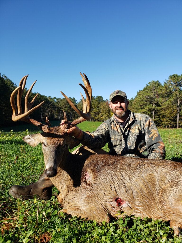 photo of hunter with big whitetail buck