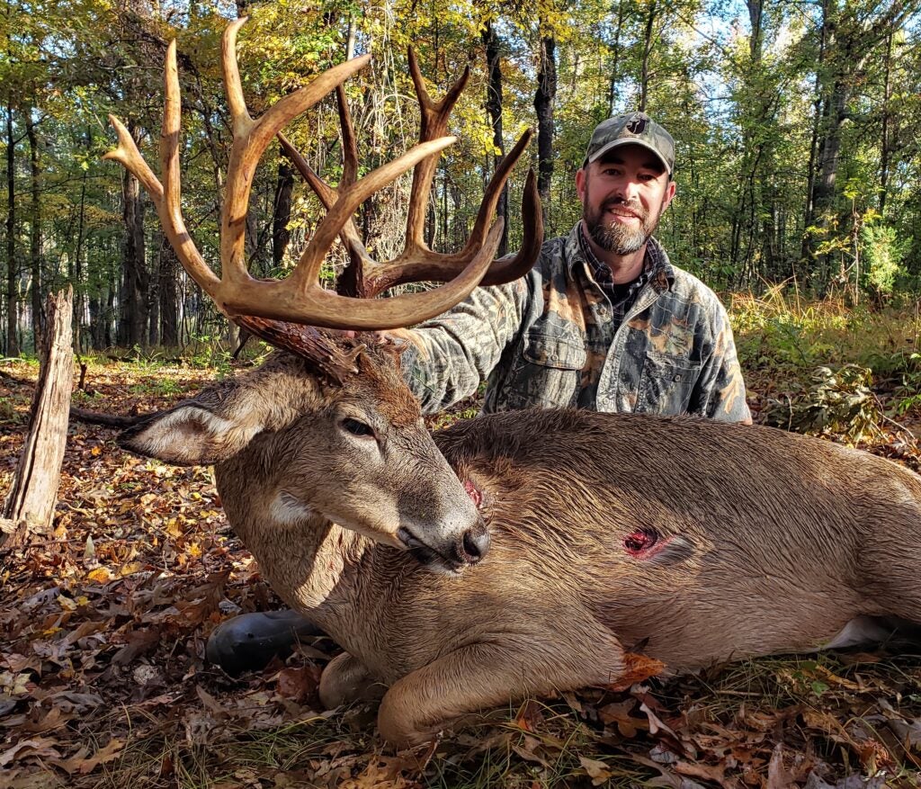 photo of hunter with big whitetail buck