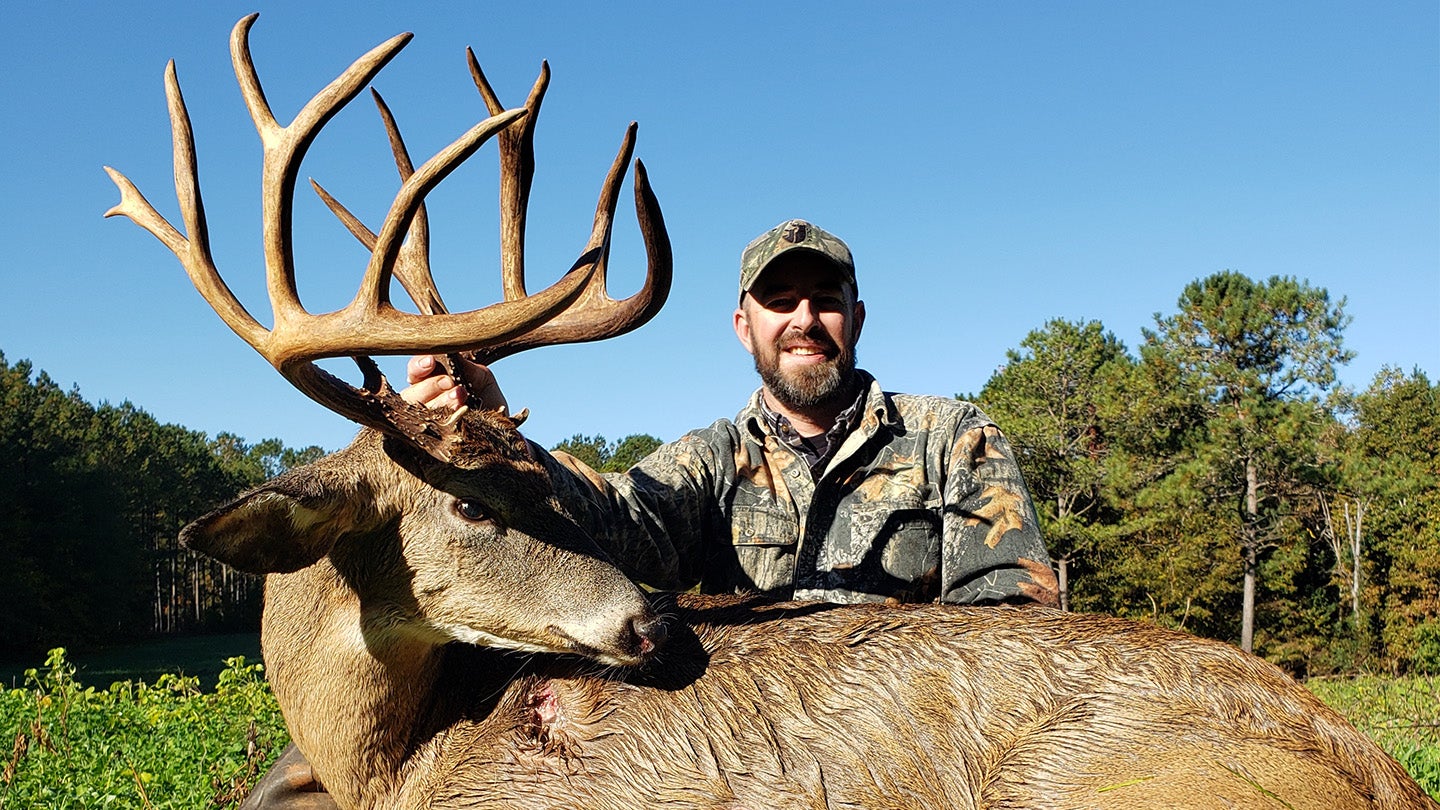 photo of hunter with trophy whitetail buck