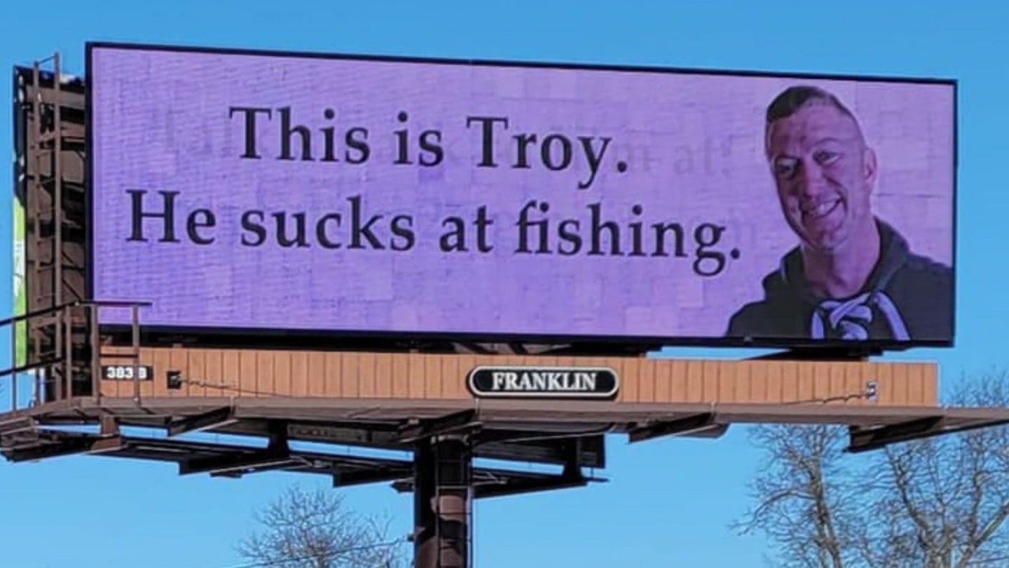 Billboard that says This is Troy. He sucks at fishing.
