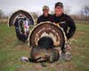 Two turkey hunters with a dead tom turkey.