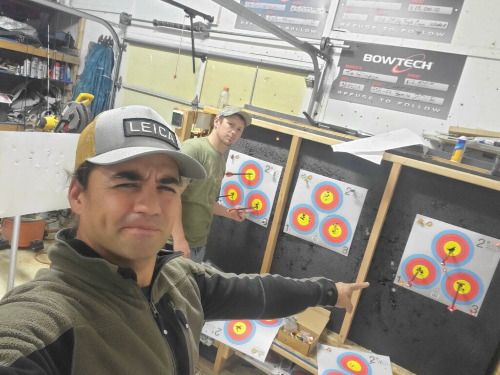 Man pointing at an archery target.