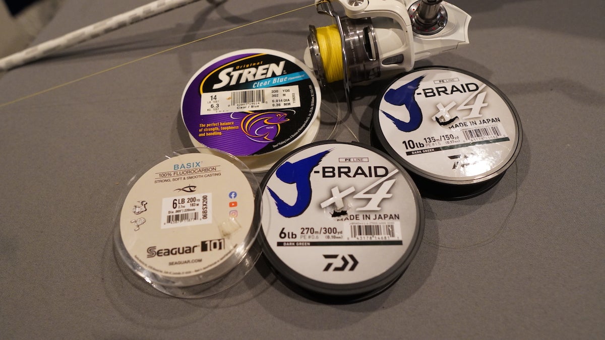 Spools of the best fishing line for bass sitting on table