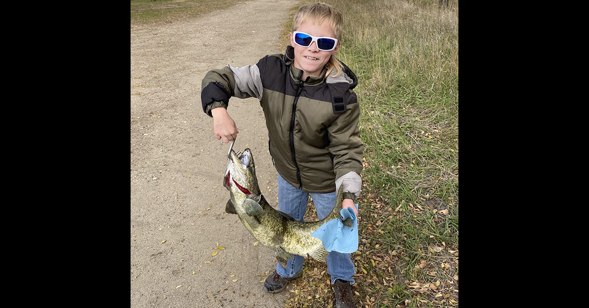boy with holds large dead chinook salmon
