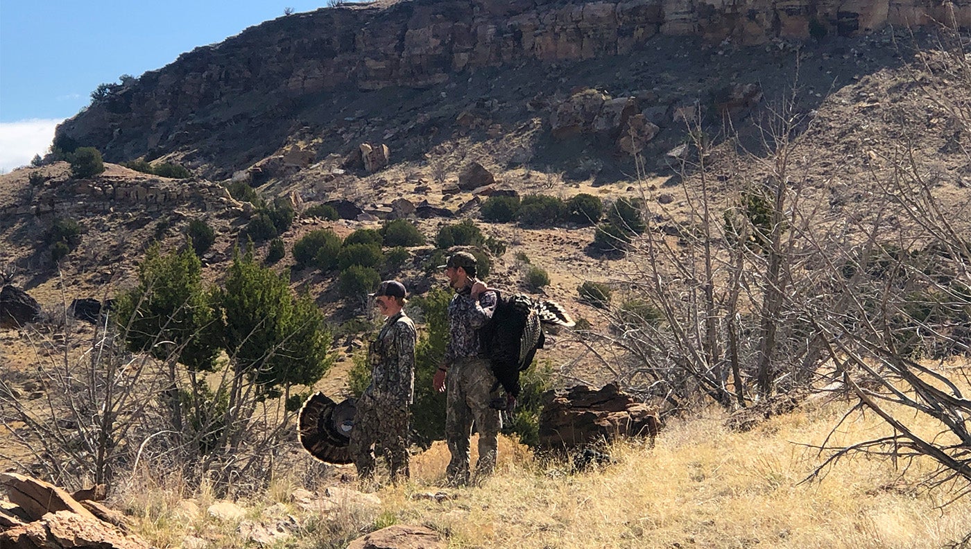 a photo of two turkey hunters in the field
