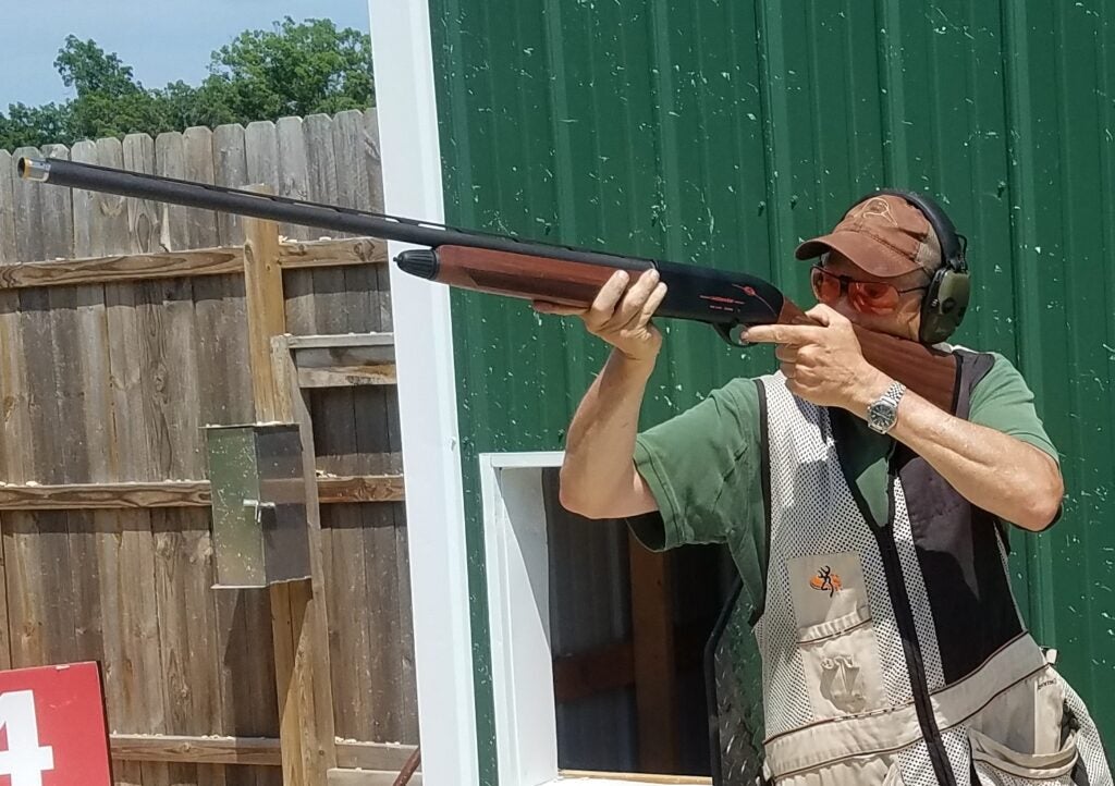 photo of man shooting shotgun