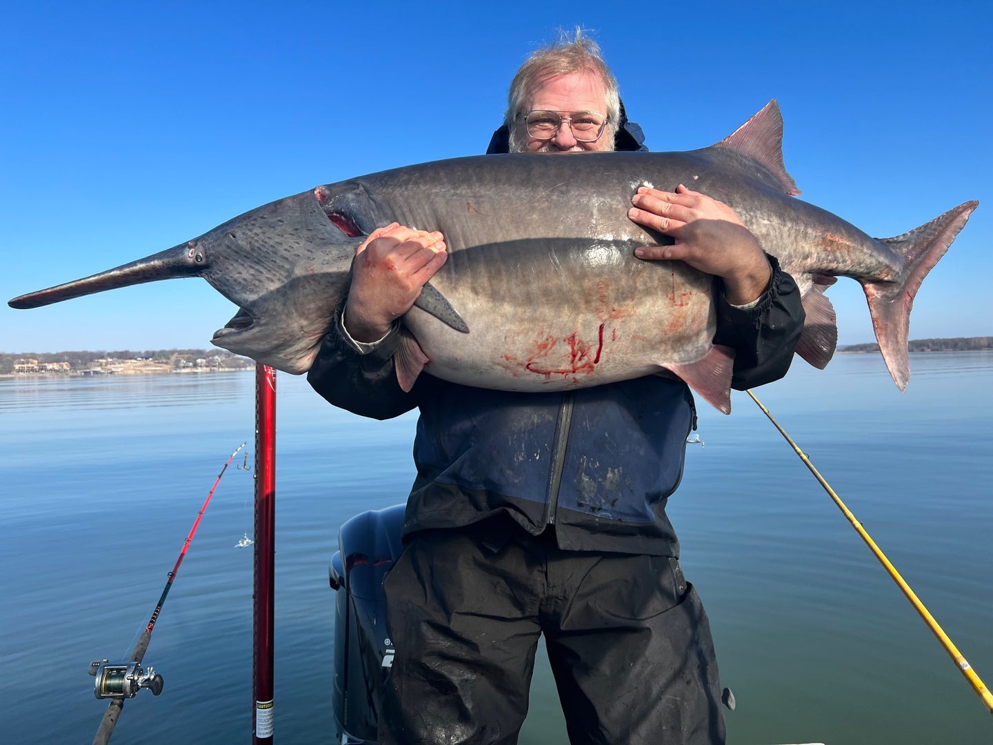 Angler John Moore with his first-ever paddlefish. It weighed 102 pounds
