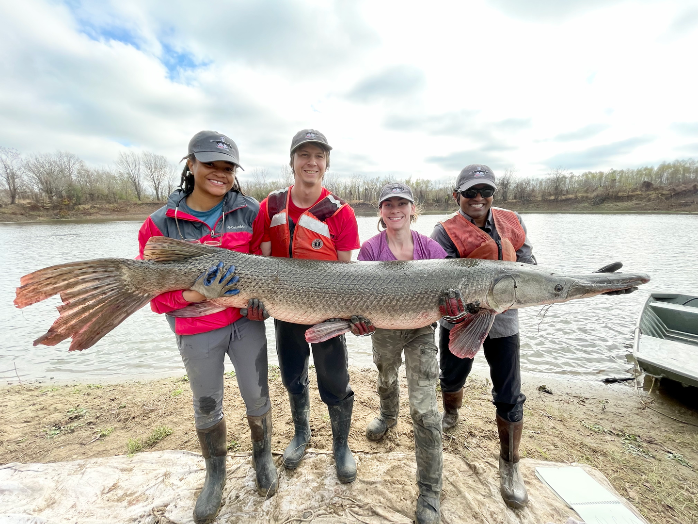 team of scientists hold large gar