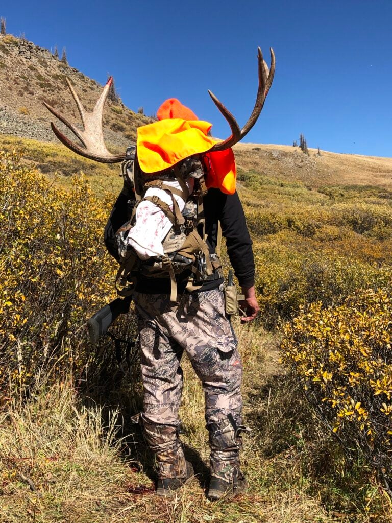 photo of hunter carrying trophy