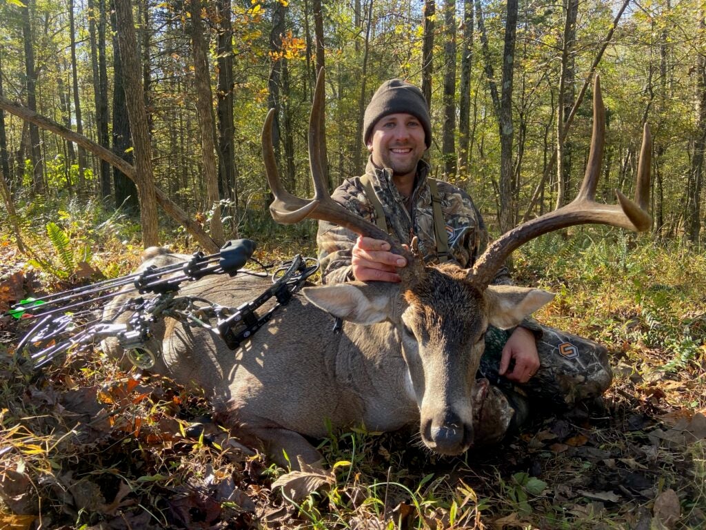 photo of a hunter with whitetail buck