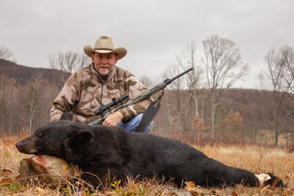 photo of hunter with black bear