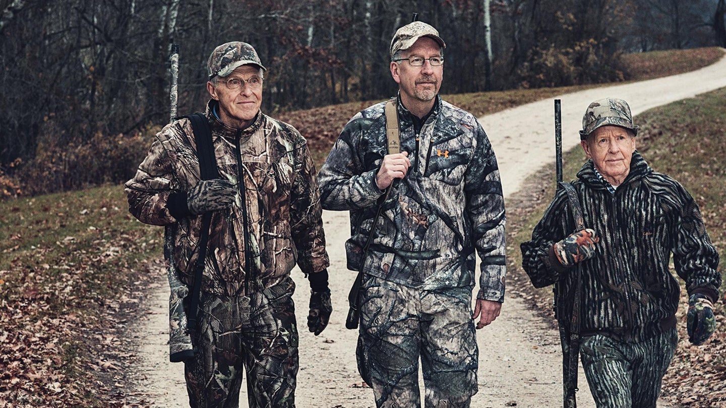 three turkey hunters walk down road