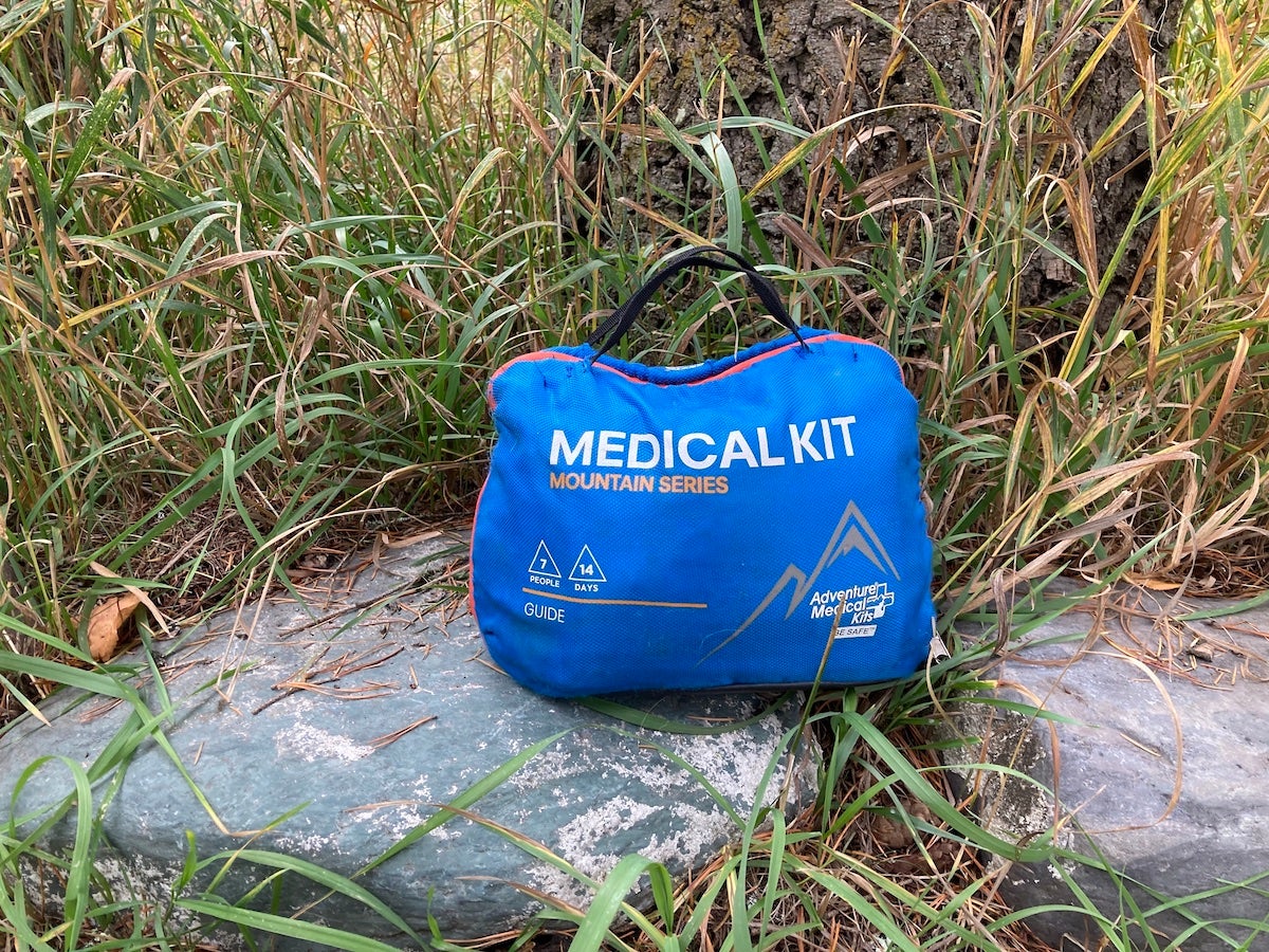 Adventure Medical Kit first aid kit sitting on rock