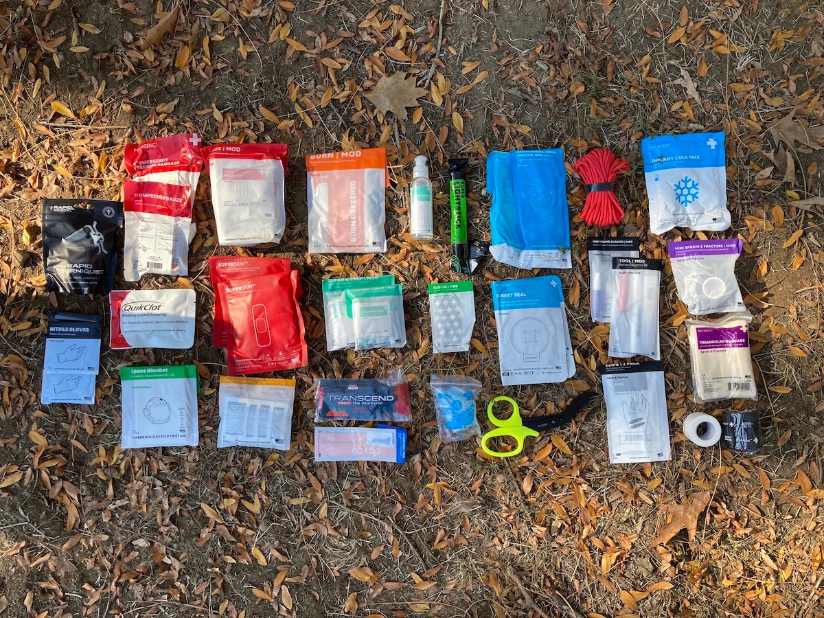 First aid kit components laid out on grass