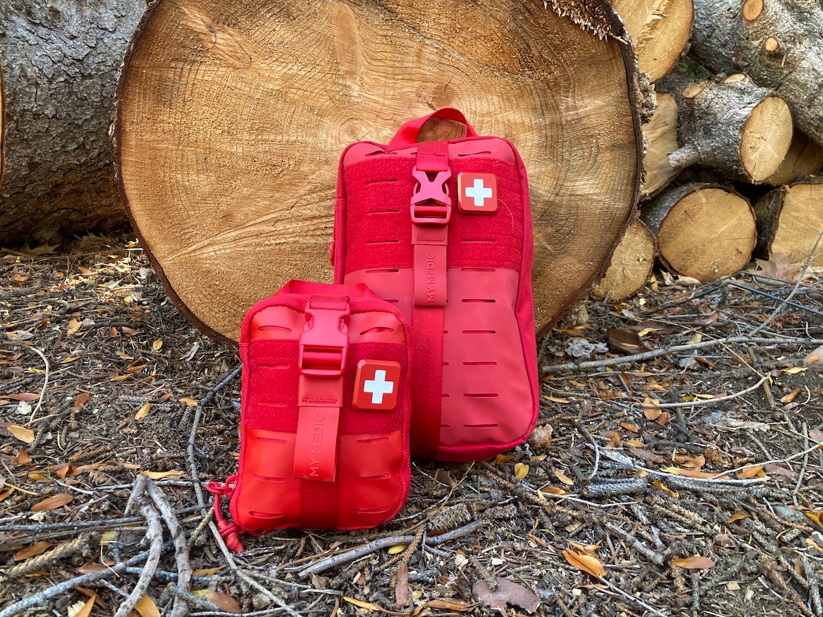 My Medic MyFak First Aid Kits leaning against tree