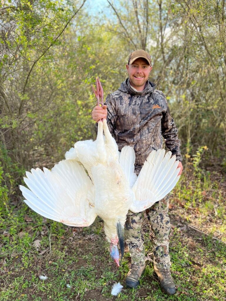 hunter holds leucitic turkey