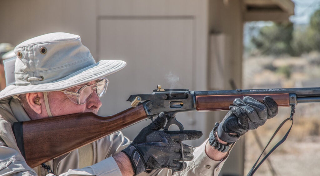 photo of shooter cycling a lever-action rifle