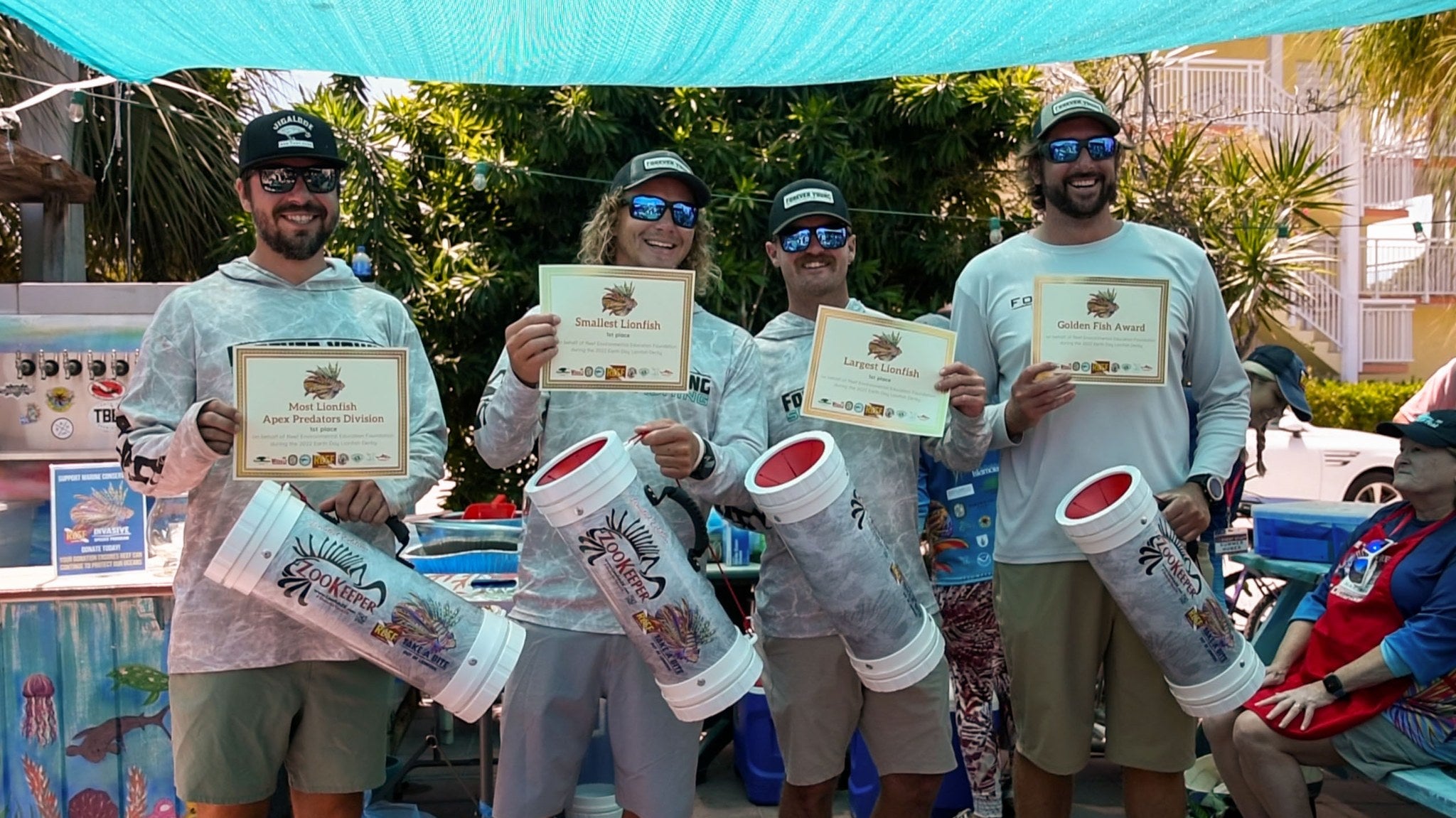 men celebrate lionfish derby with certificates